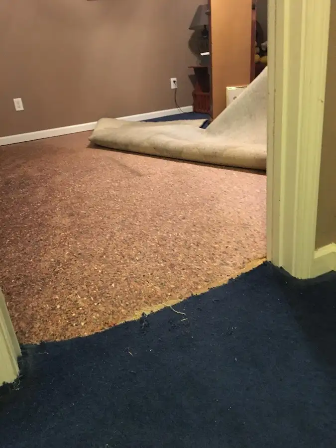 Carpet pad removal revealing water damage during Drying & Dehumidification in Broadalbin